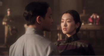 Movie still from “Farewell My Concubine” (1992), directed by Kaige Chen – A man and a woman standing next to each other; Close Up shot, Over the shoulder angle
