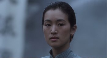 Movie still from “Farewell My Concubine” (1992), directed by Kaige Chen – A young woman with long black hair wearing a blue shirt; Close Up shot, Low angle