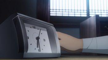 Movie still from “Fate/stay night [Heaven's Feel] II. lost butterfly” (2019), directed by Tomonori Sudô – An alarm clock sitting on top of a wooden table; Extreme Close Up shot, High angle