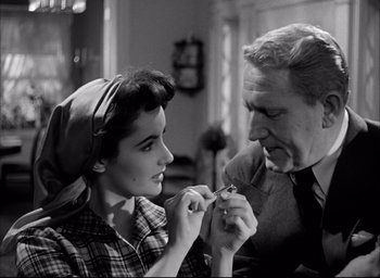 Movie still from “Father of the Bride” (1950), directed by Vincente Minnelli – An old photo of a man and a young woman; Close Up shot, High angle