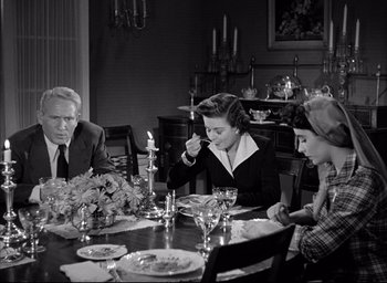 Movie still from “Father of the Bride” (1950), directed by Vincente Minnelli – An old photo of people sitting at a dinner table; Medium shot, High angle