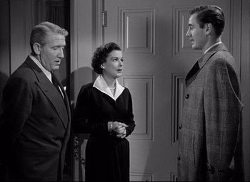 Movie still from “Father of the Bride” (1950), directed by Vincente Minnelli – Two men and a woman standing next to each other in front of a door; Medium shot, High angle