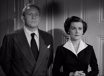 Movie still from “Father of the Bride” (1950), directed by Vincente Minnelli – An older man and woman standing next to each other; Medium shot, Low angle