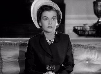 Movie still from “Father of the Bride” (1950), directed by Vincente Minnelli – An old photo of a woman wearing a hat and holding a camera; Close Up shot, Low angle
