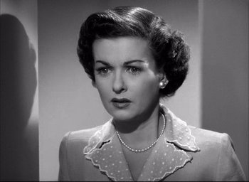 Movie still from “Father of the Bride” (1950), directed by Vincente Minnelli – An old photo of a woman in a suit; Close Up shot, Over the shoulder angle