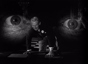 Movie still from “Father of the Bride” (1950), directed by Vincente Minnelli – A black and white photo of a man in a suit and tie; Medium shot, Low angle