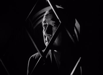 Movie still from “Father of the Bride” (1950), directed by Vincente Minnelli – A black and white photo of a man in a suit; Close Up shot, Low angle