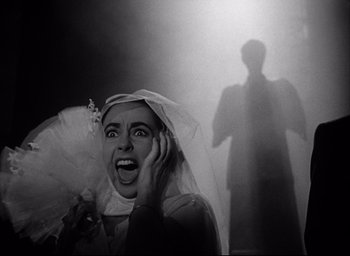 Movie still from “Father of the Bride” (1950), directed by Vincente Minnelli – A woman with a veil on her head and a veil over her face; Close Up shot, Low angle