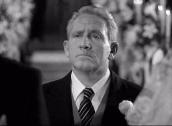 Movie still from “Father of the Bride” (1950), directed by Vincente Minnelli – Black and white photograph of a man in a suit; Close Up shot, Over the shoulder angle