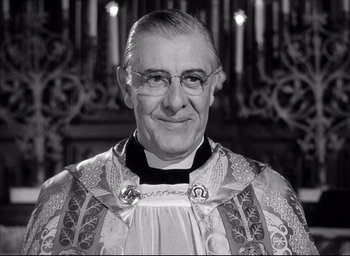 Movie still from “Father of the Bride” (1950), directed by Vincente Minnelli – An older man wearing glasses and a priest's outfit; Close Up shot, Low angle