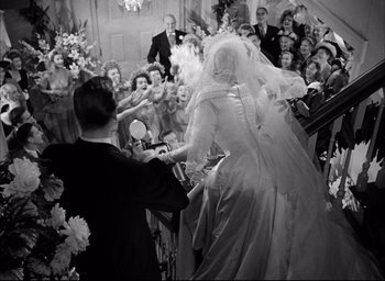Movie still from “Father of the Bride” (1950), directed by Vincente Minnelli – A black and white photo of a bride and groom; Wide shot, High angle