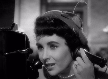 Movie still from “Father of the Bride” (1950), directed by Vincente Minnelli – An old photo of a woman with a headset on; Close Up shot, High angle