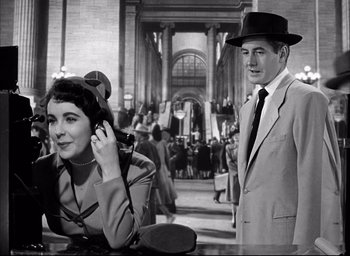 Movie still from “Father of the Bride” (1950), directed by Vincente Minnelli – An old photo of a man and a woman; Medium shot, High angle