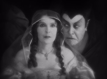 Movie still from “Faust” (1926), directed by F.W. Murnau – A man and a woman dressed as vampires; Close Up shot, High angle
