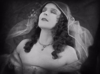 Movie still from “Faust” (1926), directed by F.W. Murnau – An old photo of a woman with a veil on her head; Close Up shot, High angle