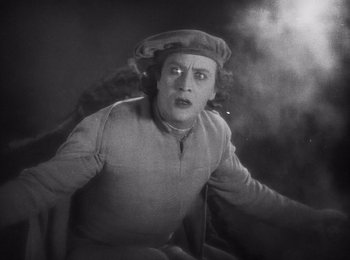 Movie still from “Faust” (1926), directed by F.W. Murnau – An old photo of a man with a hat on; Medium shot, High angle