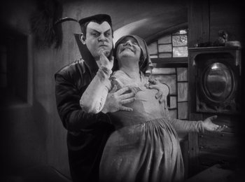 Movie still from “Faust” (1926), directed by F.W. Murnau – A man and a woman dressed up as dracula; Medium shot, Low angle