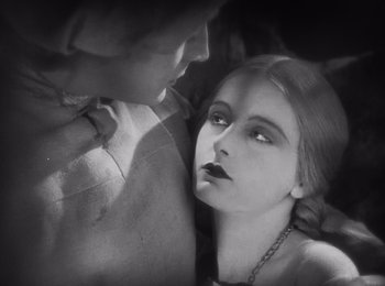 Movie still from “Faust” (1926), directed by F.W. Murnau – An old black and white photo of a woman and a man; Close Up shot, Low angle