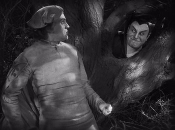 Movie still from “Faust” (1926), directed by F.W. Murnau – A black - and - white photo of a man and a woman; Medium shot, Over the shoulder angle