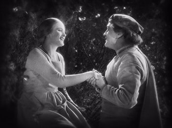 Movie still from “Faust” (1926), directed by F.W. Murnau – A man and a woman holding each other's hands; Medium shot, High angle