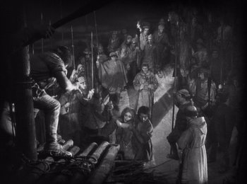 Movie still from “Faust” (1926), directed by F.W. Murnau – A black and white photo of a group of people; Wide shot, High angle