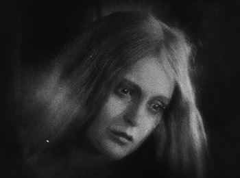 Movie still from “Faust” (1926), directed by F.W. Murnau – A black and white photo of a woman with long hair; Close Up shot, High angle