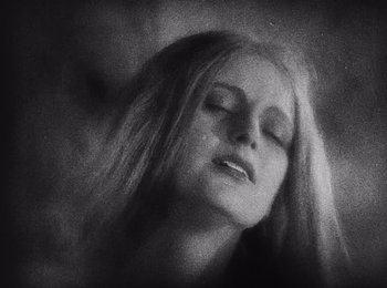 Movie still from “Faust” (1926), directed by F.W. Murnau – A black - and - white photo of a woman with long hair; Close Up shot, High angle