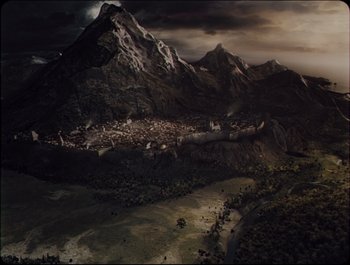 Movie still from “Faust” (2011), directed by Aleksandr Sokurov – An aerial view of a city and mountains in the background; Extreme Wide shot, Overhead angle