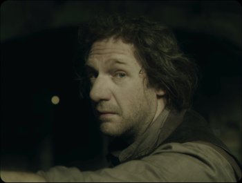 Movie still from “Faust” (2011), directed by Aleksandr Sokurov – A person with long hair; Close Up shot, Over the shoulder angle