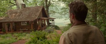 Movie still from “The Shack” (2017), directed by Stuart Hazeldine – A man standing in front of a log cabin; Wide shot, Over the shoulder angle