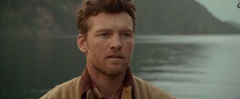 Movie still from “The Shack” (2017), directed by Stuart Hazeldine – A person wearing a jacket near a body of water; Close Up shot, Over the shoulder angle