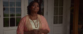 Movie still from “The Shack” (2017), directed by Stuart Hazeldine – An older woman wearing a necklace and a pink jacket; Close Up shot, Over the shoulder angle