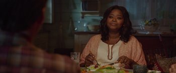 Movie still from “The Shack” (2017), directed by Stuart Hazeldine – A woman sitting at a table with a plate of food; Medium shot, Over the shoulder angle