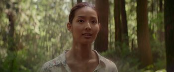 Movie still from “The Shack” (2017), directed by Stuart Hazeldine – A woman in a floral shirt in front of a forest; Close Up shot, Low angle