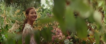 Movie still from “The Shack” (2017), directed by Stuart Hazeldine – A woman standing next to a tree with lots of leaves; Medium shot, Low angle
