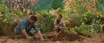 Movie still from “The Shack” (2017), directed by Stuart Hazeldine – A man and a woman working in a garden; Wide shot, High angle