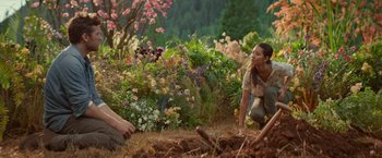 Movie still from “The Shack” (2017), directed by Stuart Hazeldine – A woman kneeling down next to a man in a field; Wide shot, Over the shoulder angle