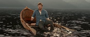 Movie still from “The Shack” (2017), directed by Stuart Hazeldine – A man sitting on a boat in the middle of the ocean; Wide shot, High angle