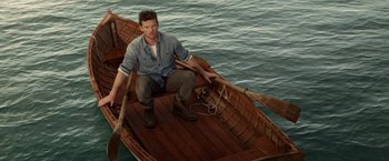 Movie still from “The Shack” (2017), directed by Stuart Hazeldine – A man sitting on a boat in the water; Wide shot, High angle