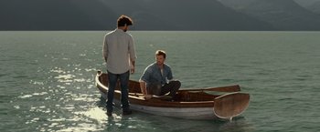 Movie still from “The Shack” (2017), directed by Stuart Hazeldine – Two men are sitting on a boat in the water; Wide shot, High angle