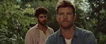 Movie still from “The Shack” (2017), directed by Stuart Hazeldine – Two men standing next to each other near a forest; Close Up shot, Over the shoulder angle