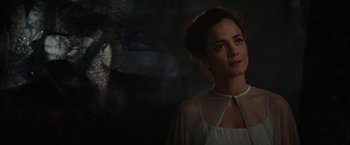 Movie still from “The Shack” (2017), directed by Stuart Hazeldine – A woman in a white dress standing in front of a stone wall; Close Up shot, Over the shoulder angle
