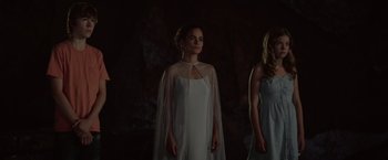 Movie still from “The Shack” (2017), directed by Stuart Hazeldine – A woman in a white dress standing next to another woman in a white dress; Medium shot, Low angle
