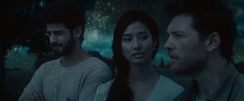 Movie still from “The Shack” (2017), directed by Stuart Hazeldine – A woman standing next to two men in front of a forest; Close Up shot, Over the shoulder angle