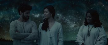 Movie still from “The Shack” (2017), directed by Stuart Hazeldine – A woman standing next to a man in front of a night sky; Medium shot, Low angle