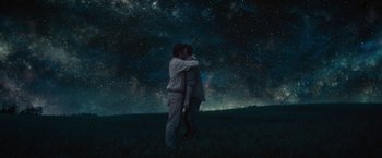 Movie still from “The Shack” (2017), directed by Stuart Hazeldine – Two people kissing in a field under a night sky; Wide shot, Low angle