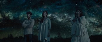 Movie still from “The Shack” (2017), directed by Stuart Hazeldine – A group of people standing in front of a night sky; Wide shot, Low angle