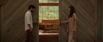 Movie still from “The Shack” (2017), directed by Stuart Hazeldine – A man and a woman standing in front of an open door; Wide shot, Low angle