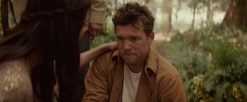 Movie still from “The Shack” (2017), directed by Stuart Hazeldine – A man sitting in the woods with a woman touching his shoulder; Close Up shot, Over the shoulder angle