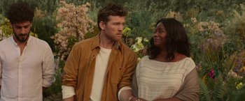 Movie still from “The Shack” (2017), directed by Stuart Hazeldine – A man and a woman standing next to each other in front of flowers; Medium shot, Over the shoulder angle